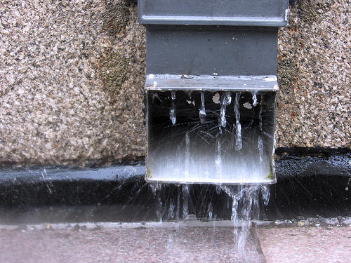 Photo of rainwater coming out of a downpipe